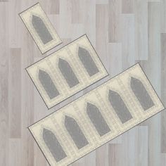 three rugs with arches on them sitting on a wooden floor next to each other