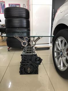 a table made out of car parts on the floor