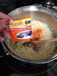 someone is adding seasoning to rice in a pot