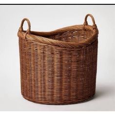 a brown wicker basket sitting on top of a white table