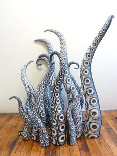 an octopus sculpture sitting on top of a wooden floor