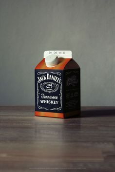 a bottle of jack daniels whiskey sitting on top of a wooden table