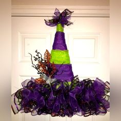 a purple and green christmas tree on top of a door