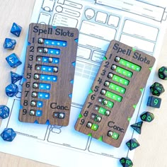 two wooden dice sets sitting on top of a table next to blue and green dice