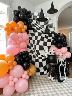 balloons are arranged in the shape of black and white figures