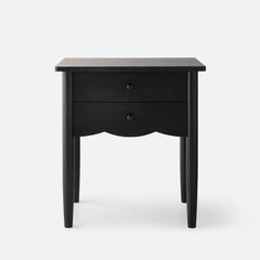 a small black table with two drawers on one side and an open drawer on the other