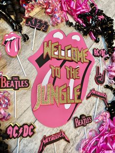 the rolling stones'welcome to the jungle sign surrounded by lollipop stickers