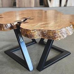 a wooden table with metal legs on concrete