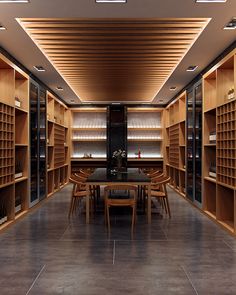 a dining room with wooden shelves and chairs in it, along with a long table