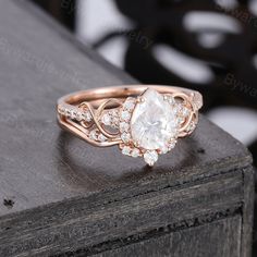 a rose cut diamond engagement ring on top of a wooden table with black and white background