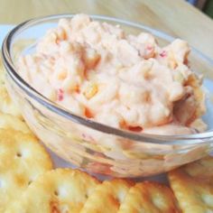 some crackers and dip in a bowl on a table