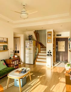 a living room filled with furniture and a staircase