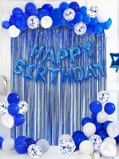 a blue and white birthday backdrop with balloons