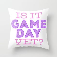 a white pillow with pink lettering that says is it game day yet? on it