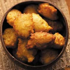 a bowl filled with fried food on top of a table