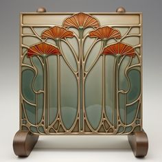 an art deco glass panel with three flowers on the front and sides, set against a white background