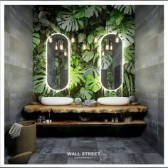 a bathroom with two sinks and mirrors in front of a wall covered with green plants