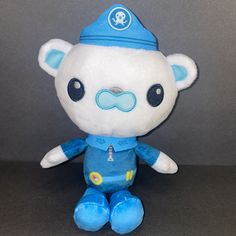 a blue and white teddy bear wearing a hat