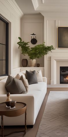 a living room filled with furniture and a fire place in the middle of it's wall