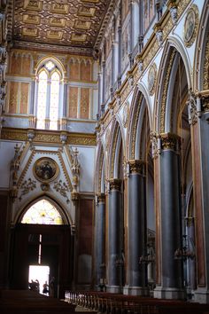 the interior of an old church with gold and white decor