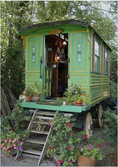 a green caboose with stairs leading up to it