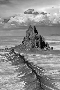 a black and white photo of an island in the ocean