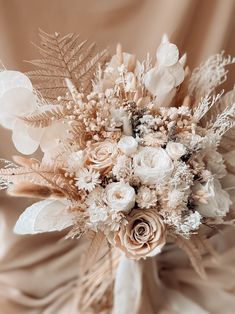 a bridal bouquet with white and beige flowers