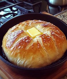 a loaf of bread sitting in a pan on top of a stove