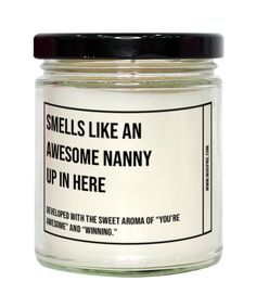 a jar of white candles with black lid that says smells like an awesome nanny up in here