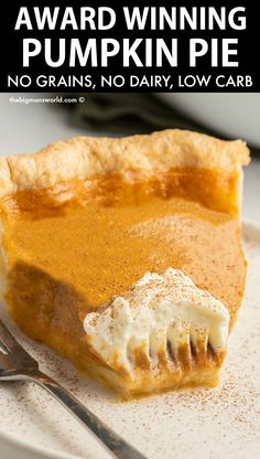 a slice of pumpkin pie on a white plate with a fork and knife next to it