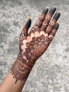 henna tattoo on the palm of a woman's hand