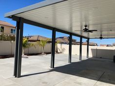 an empty patio with a ceiling fan on it