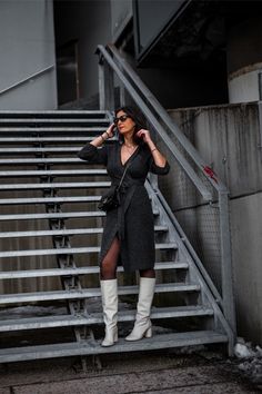 Whoever claimed that a knit wrap dress must be dull clearly hasn't explored its full potential! | How To Wear A Knit Wrap Dress: Wrap It Up & Unleash Your Style | Grey Knit Wrap Dress Winter Outfits, White Boots, Black Tights