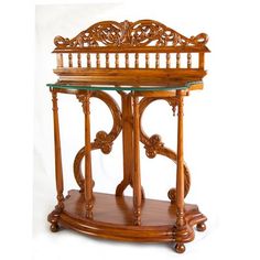 an ornate wooden table with glass top