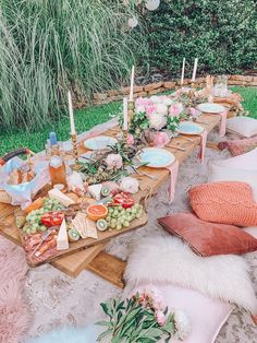 a long table with food and candles on it