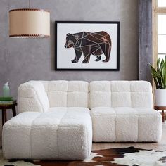 a living room with a white couch and rug