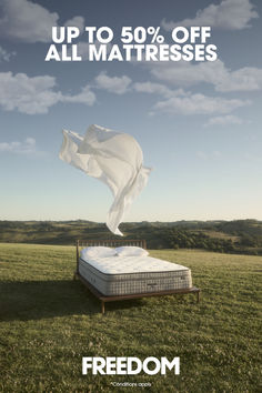 a mattress on top of a bed in the middle of a field