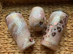 three pink tumbles sitting on top of a wicker basket