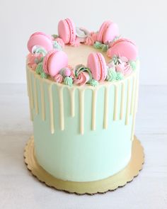 a frosted cake with pink and green icing