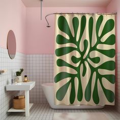 a bathroom with pink walls and green leaf shower curtain