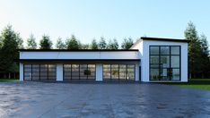 a large garage with two cars parked in front of it and lots of windows on the side