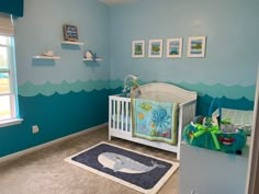 a baby's room decorated in blue and green