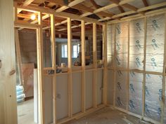 the inside of a house being built with wood framing and insulation tape on the walls