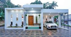 a white car parked in front of a house with two doors and windows on each side