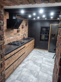 a kitchen with brick walls and black appliances on the counter top, along with an oven