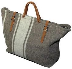 a gray and white striped bag with brown handles