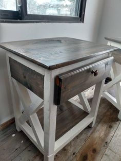 an old wooden table with two chairs next to it and a window in the background