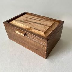 a small wooden box sitting on top of a white table