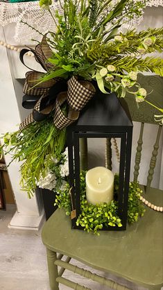 a green chair with a candle and some plants