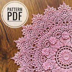 a pink doily sitting on top of a wooden table